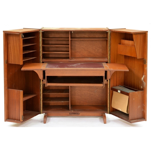 542 - A mid-century modern Newcraft teak 'Home Office', of triptych form with fitted interior and sliding ... 