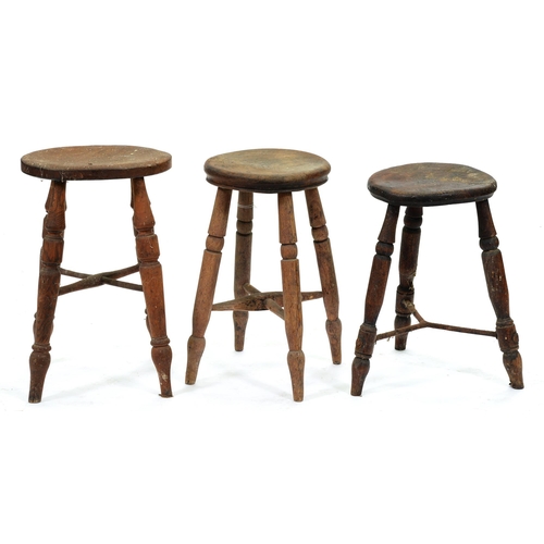 544 - Three Victorian ash and elm three or four legged stools, with turned or iron stretchers, 47-53cm h... 