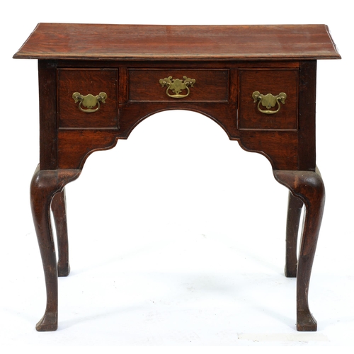 549 - An oak lowboy, 19th c, with three cockbeaded drawers about the arched apron, on moulded cabriole leg... 