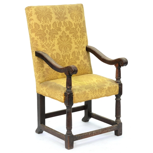 550 - An oak armchair, the over-scrolled arms terminating in volutes on barrel supports, with conforming l... 