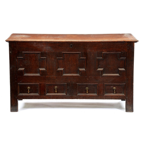 551 - A George III oak mule chest, the lid with ovolo lip above geometric panelled front and two drawers, ... 