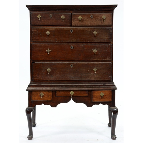 554 - A George III oak chest on stand, the upper part with stepped cornice above two short and three gradu... 