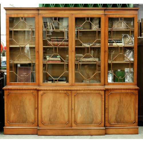 571 - A mahogany breakfront bookcase, 20th c, with dentil cornice, crossbanded and line inlaid throughout,... 