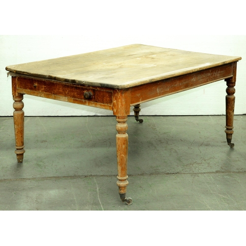 575 - A Victorian pine kitchen table, fitted with a drawer on turned legs, retaining traces of the origina... 