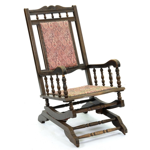 576 - A stained beech American rocking chair, c1910