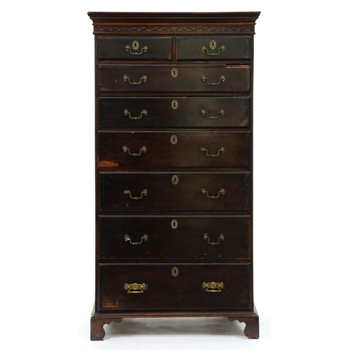 580 - A mahogany tallboy, early 20th c, with blind fret carved cornice and brass handles and escutcheons, ... 