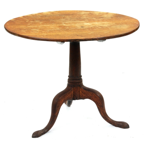 600 - A George III oak tripod table, the round tip-up top on turned pillar, 68cm h; 83cm diam... 