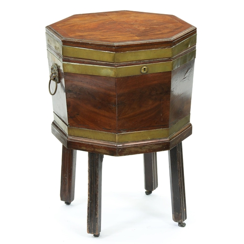 611 - A George III brass bound mahogany wine cooler, the moulded, crossbanded lid in richly figured veneer... 