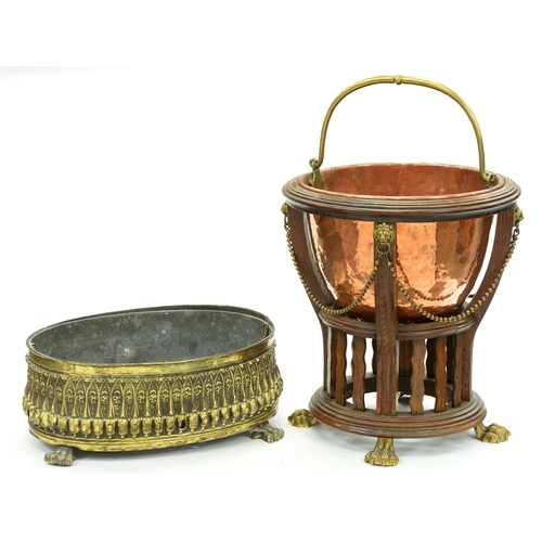 653 - An Edwardian brass mounted oak jardiniere, early 20th c, with beaded festoons, on brass feet, helmet... 