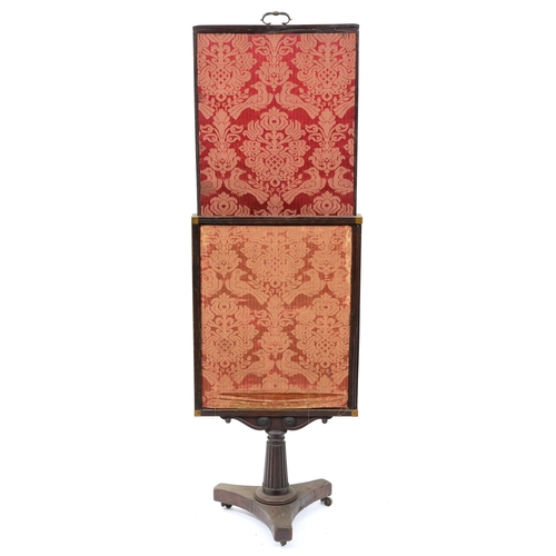 671 - An early Victorian mahogany cheval firescreen, on fluted pillar and tripartite base with brass casto... 