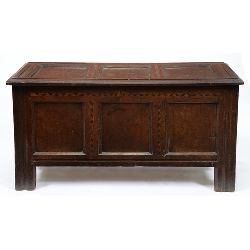 679 - A Charles II oak chest, with three panel lid and front inlaid with holly and bog oak, on channelled ... 