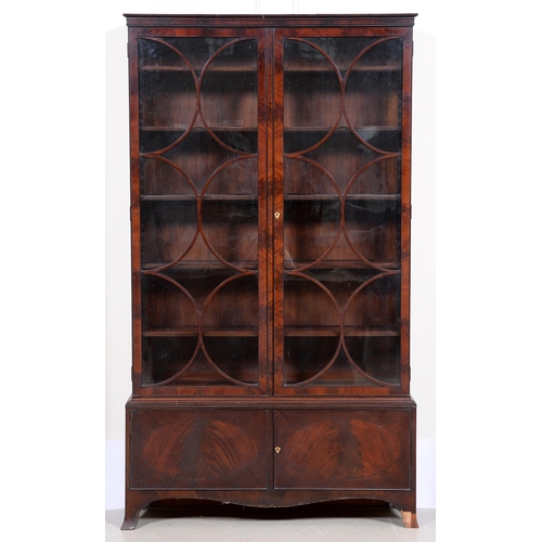 683 - A George III mahogany bookcase, of finely figured timber with adjustable shelves enclosed by a pair ... 