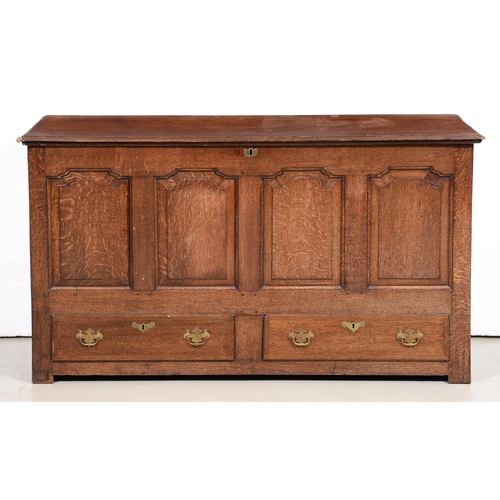 686 - A George III oak mule chest, the front having four raised and fielded ogee panels above two moulded ... 