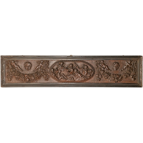 696 - An Italian carved oak frieze, late 19th c, with a central group of seven putti and billing doves fla... 