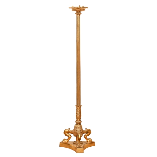 708 - A gilt bronze torchere, 20th c, in Empire style, on three lion monopodia and platform, 125cm h... 