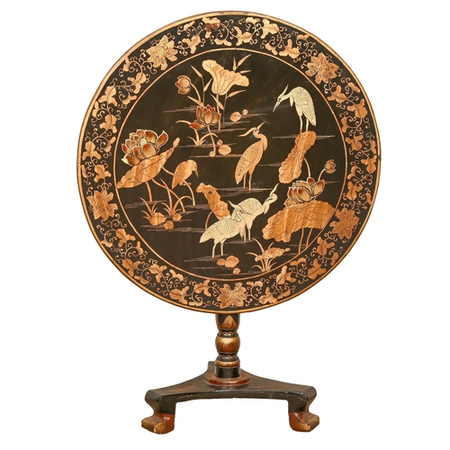 716 - A Chinese black and gold export lacquer pedestal table, 19th c, the tip-up top with egrets in a wate... 