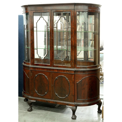 721 - A bow ended mahogany china cabinet, c1930, with mirror back and plate glass shelves, enclosed by pai... 