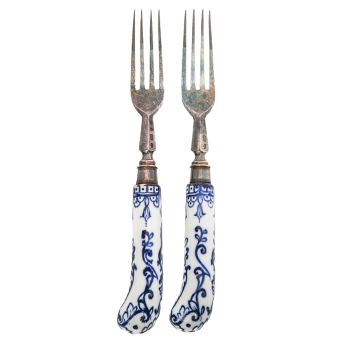 73 - A pair of electro-plated dessert forks with  French blue and white pistol hafts,  painted  in the st... 