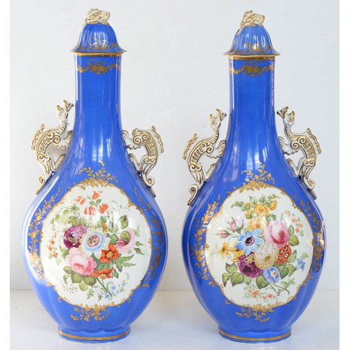 75A - A pair of Staffordshire dragon handled bone china bottle shaped vases and covers, c1850, painted to ... 