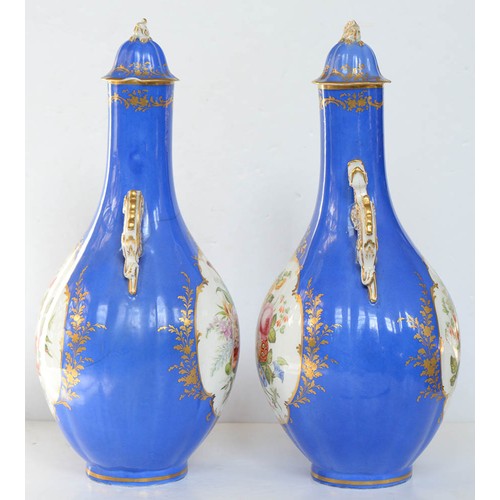 75A - A pair of Staffordshire dragon handled bone china bottle shaped vases and covers, c1850, painted to ... 