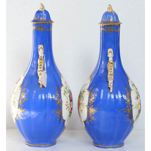 75A - A pair of Staffordshire dragon handled bone china bottle shaped vases and covers, c1850, painted to ... 