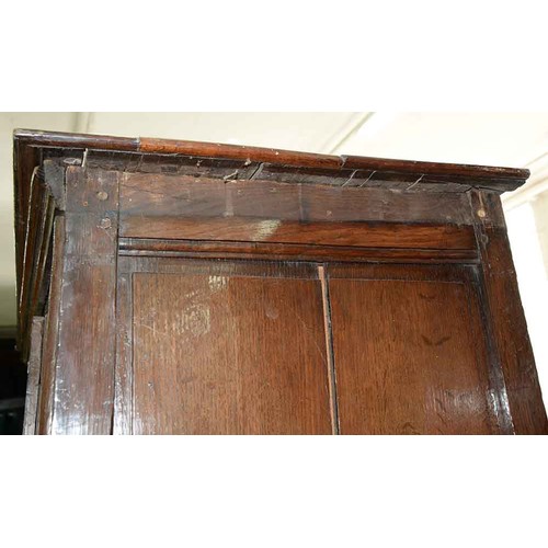 591 - A George III joined oak press, North West England, with raised and fielded panels, the off centre th... 