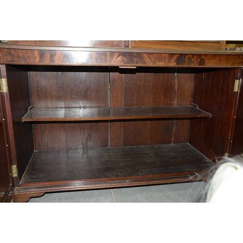 977 - A mahogany bookcase, early 19th c, with stepped cornice and figured frieze, fitted with adjustable s... 