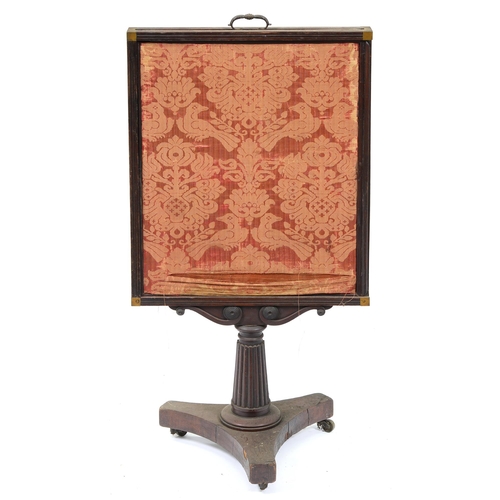 1093 - An early Victorian mahogany cheval firescreen, on fluted pillar and tripartite base with brass casto... 