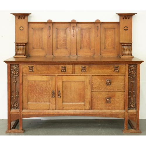 1076 - An English Arts and Crafts oak and inlaid sideboard, c1910, the panelled upstand flanked by pillars ... 