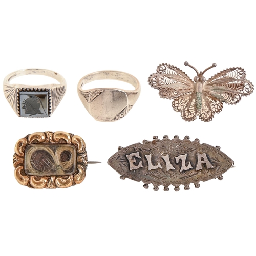 109 - A giltmetal mourning brooch, a silver ELIZA name brooch, two silver signet rings and a butterfly fil... 