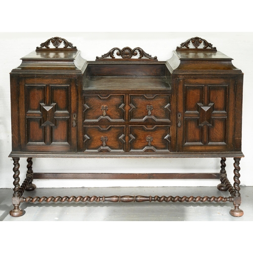 1103 - An oak geometrically moulded sideboard, early 20th c, with stepped top on barley turned legs with co... 