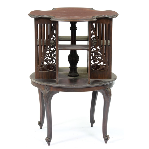 1113 - An Edwardian round mahogany book stand, with fretted divisions and shelves on carved cabriole legs, ... 