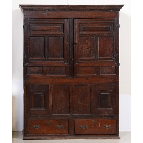 1116 - A George III oak press, the stepped cornice above panelled doors with gothic style steel hinges, the... 