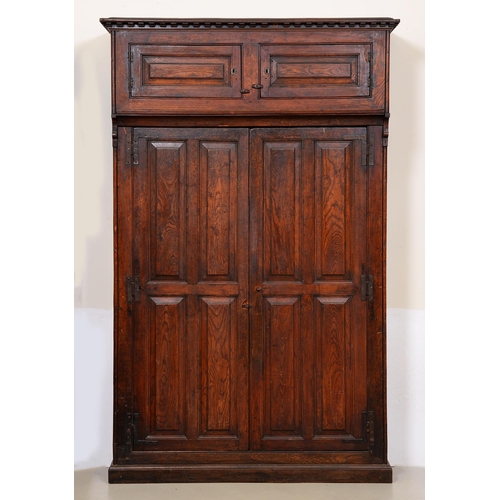 1117 - A Northern European oak armoire, 19th c, the dentil cornice to the slightly projecting upper part en... 