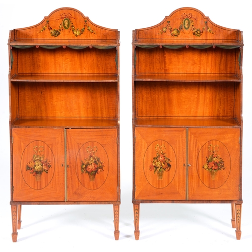 1120 - A pair of Edwardian painted satinwood open bookcases, with classical cameos and festoons, the lower ... 