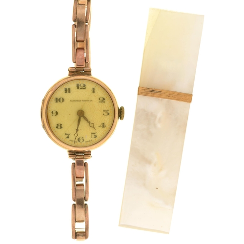 28 - A Tavannes 9ct gold lady's wristwatch, 26mm diam, import marked London 1924, on a gold coloured meta... 