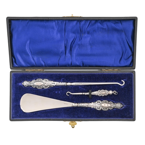 351 - An Edwardian silver handled set of shoe horn button hook and glove button hook, Birmingham and Sheff... 