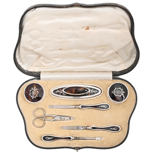 359 - A George V silver inlaid tortoiseshell inset silver manicure set, of six pieces and scissors, by Wal... 