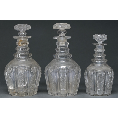 576 - A fine pair of late Regency triple ring neck glass decanters and a half bottle decanter en suite, c1... 