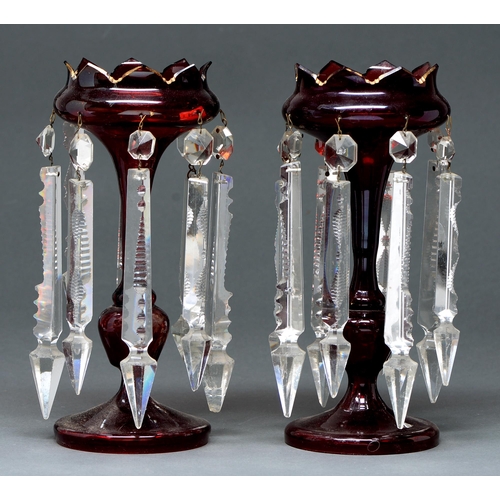 589 - A pair of ruby glass lustres, late 19th c, with gilt rim and prismatic cut glass beads and pendants,... 