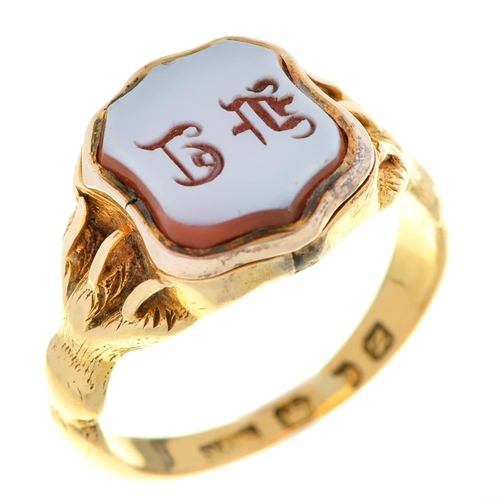 60 - A Victorian gold signet ring, the shield shaped agate intaglio with claw shoulders, the underside en... 