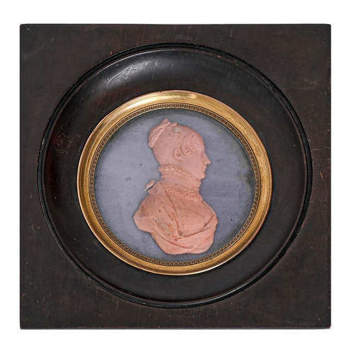 639 - A French wax bas relief portrait miniature of a lady, 19th c, 77mm diam, pearwood frame with gilt br... 