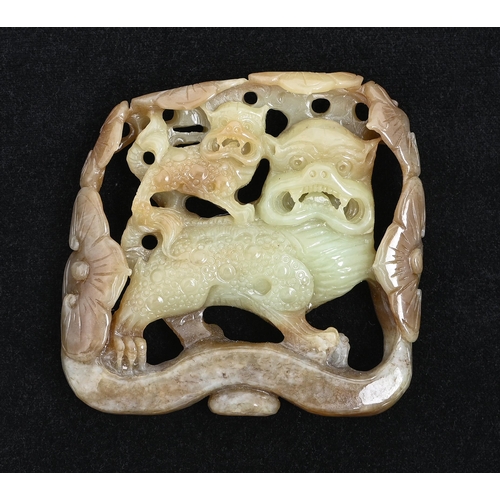 642 - A Chinese jade pebble carving of dogs of Fo within flowers, 88mm h