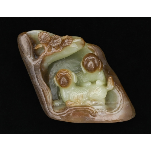 652 - A Chinese jade pebble carving of two dogs in a cave, 90mm h