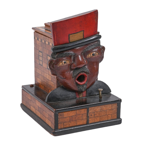 672 - Smoking. A French  carved and painted wood cigarette dispenser in the form of the head of a gendarme... 