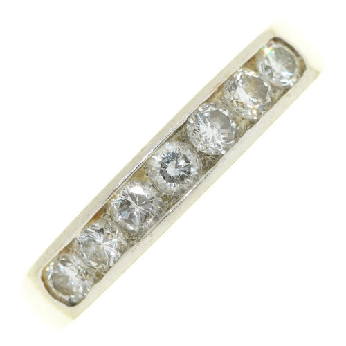 70 - A seven stone diamond ring, with round brilliant cut diamonds, flush set in line, in 18ct white gold... 