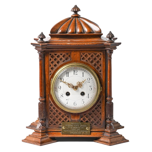 708 - A Continental walnut mantel clock, c1900, the pillar shaped case with lobed top and finials, the sid... 