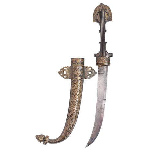 715 - A Moroccan dagger and sheath, jambiya, c1900, with wire inlaid ebony hilt, chased brass sheath with ... 