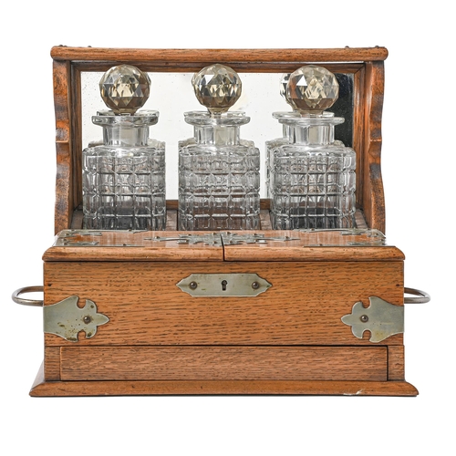 727 - An Edwardian EPNS mounted oak tantalus, 32cm h and a set of three cut glass decanters and stoppers... 