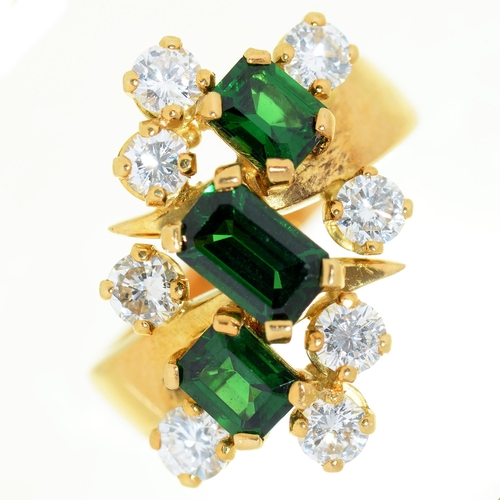 79 - A diamond ring, with three step cut green tourmalines, in gold marked 18, 8.5g, size L... 